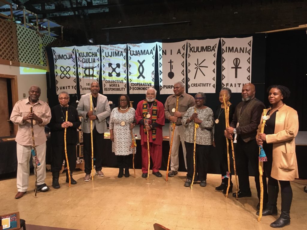 Milwaukee's ten African American environmental pioneers standing in a row. They're holding the walking sticks and wearing the medallions they were honored with. 