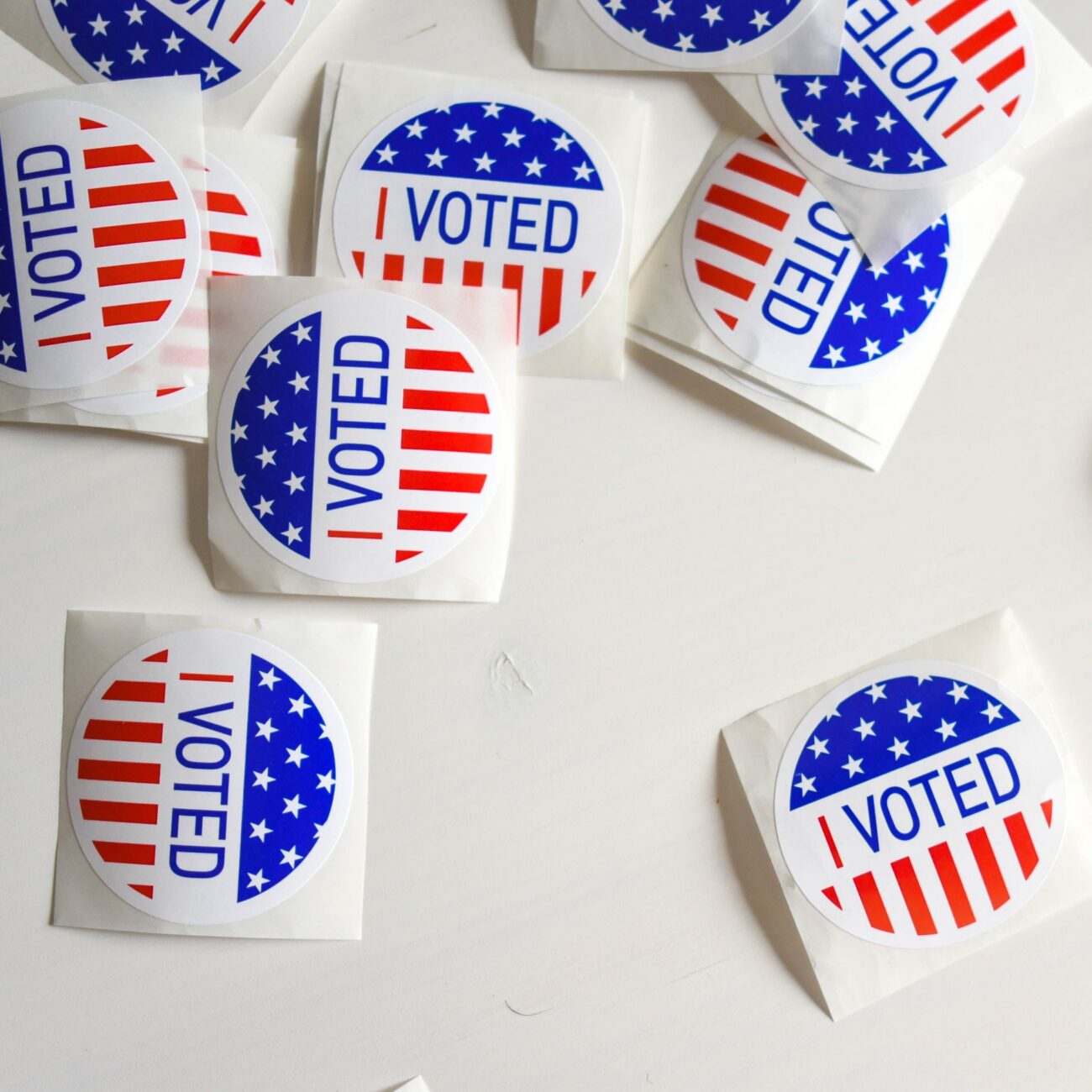 "I voted" stickers scattered on a white table.